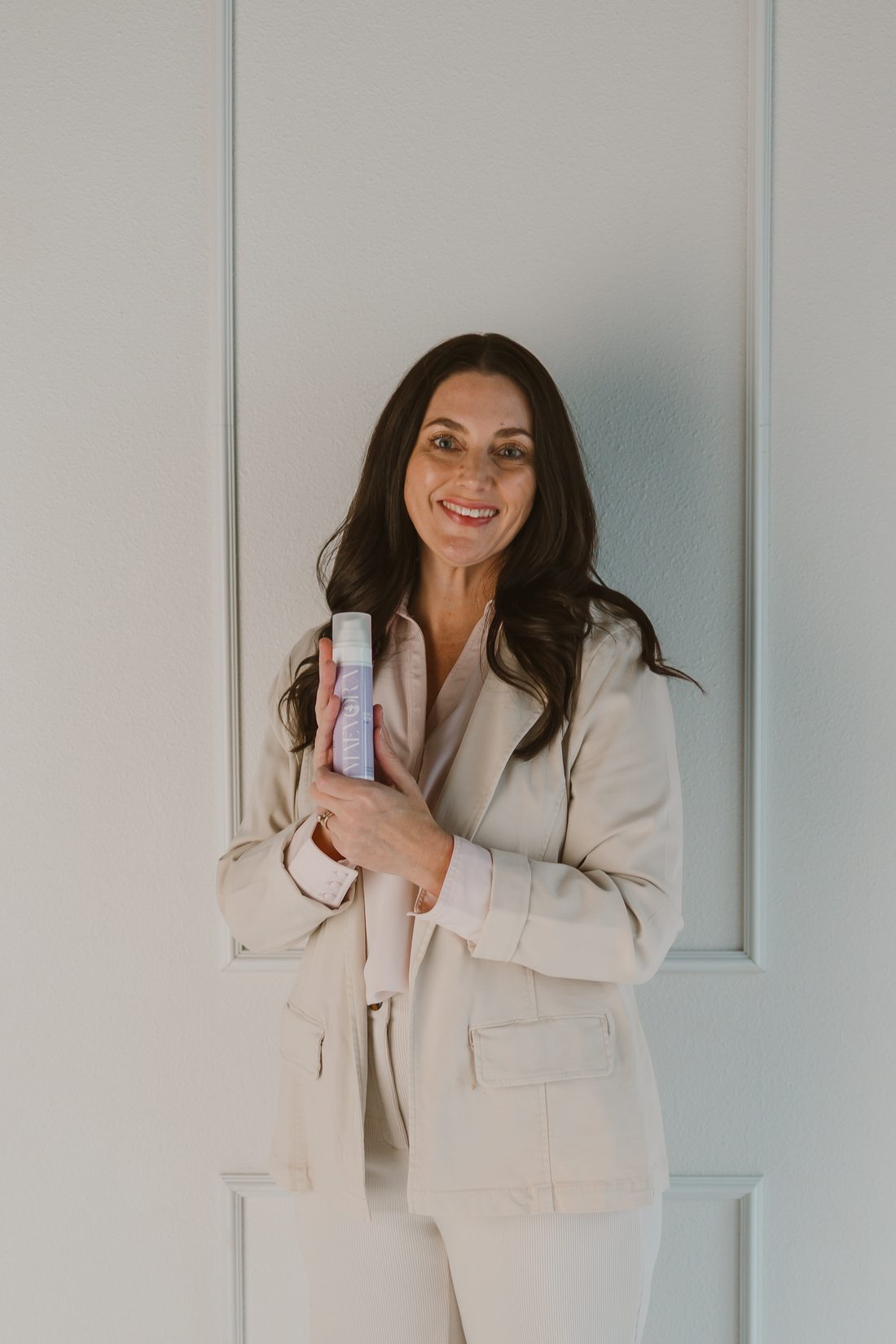 Mandy Heard, licensed esthetician, holding a MaeVora bottle